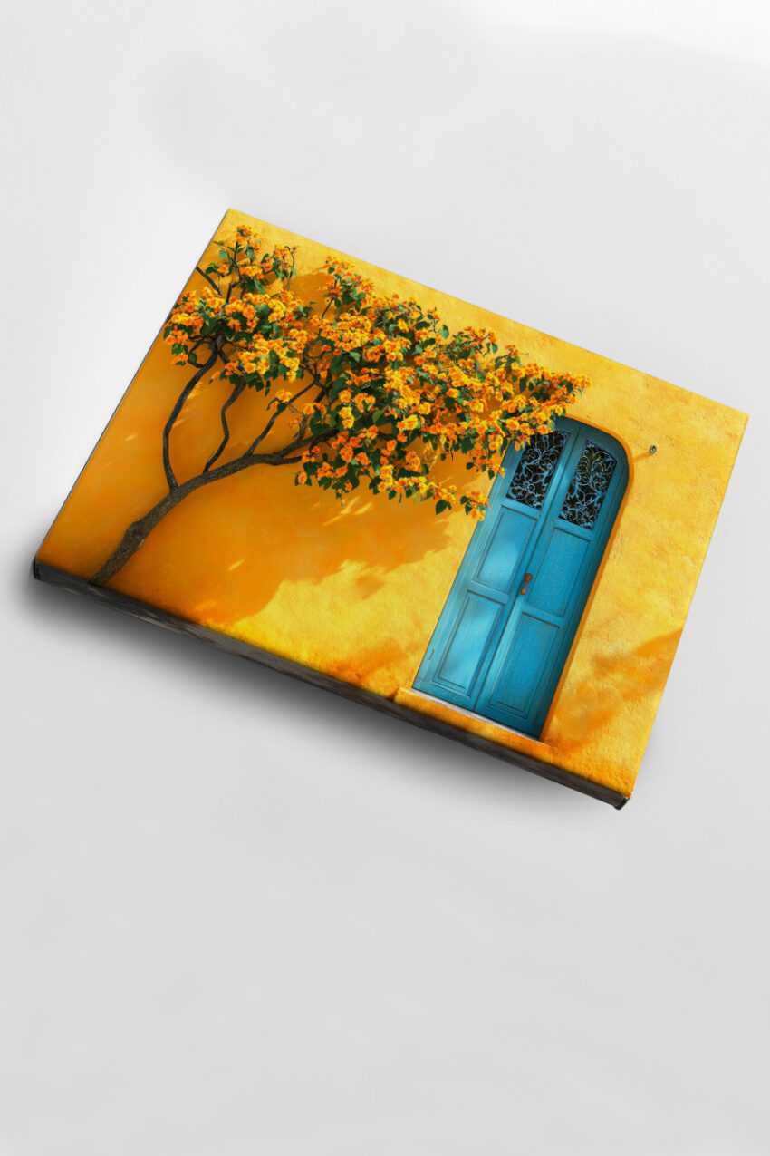Kunstdruck mit blühendem Orangenbaum vor gelber Wand und blauem Holztür in warmen Farben